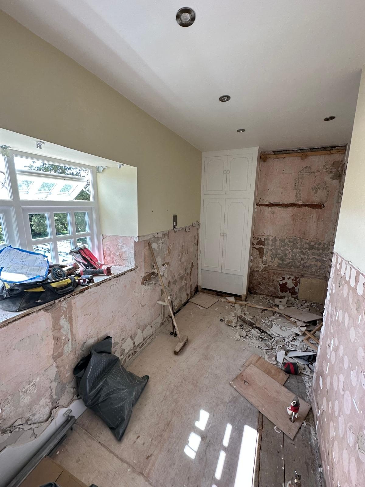 Before: bathroom stripped back to bare walls