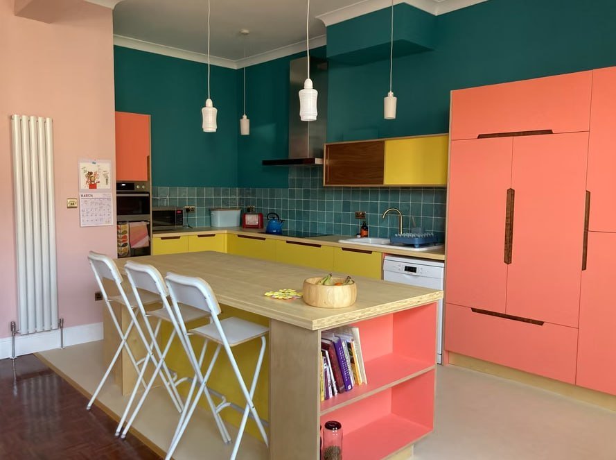 Modern kitchen with coral, teal and yellow cabinetry by Fresh Start Living