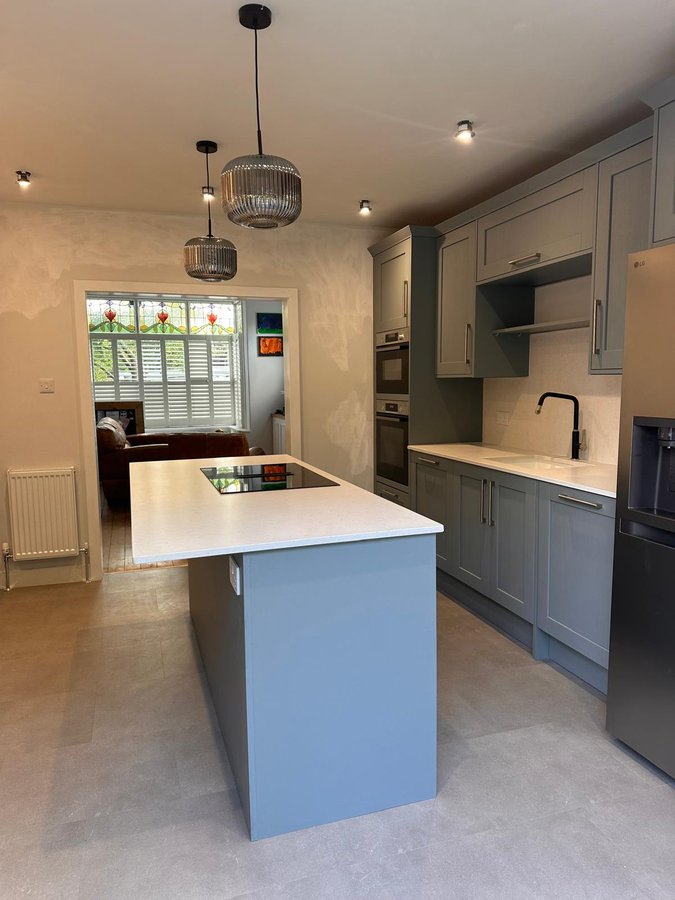 After: modern kitchen with sage cabinetry and island